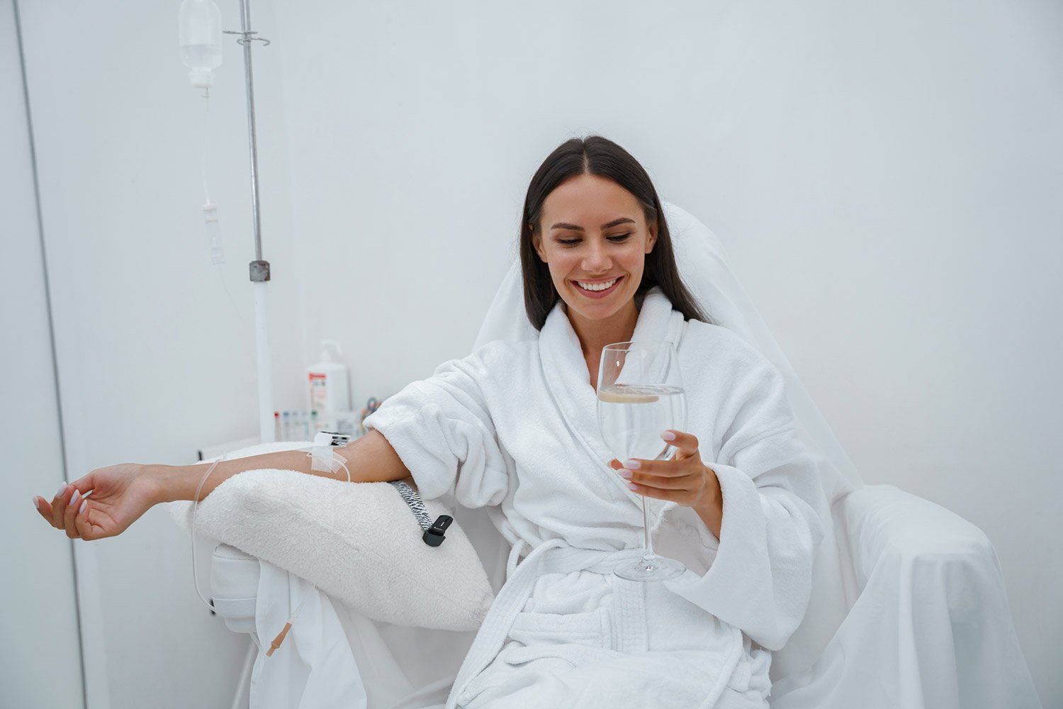 beautiful-woman-white-bathrobe-drink-water-medical-procedure-beauty-clinic