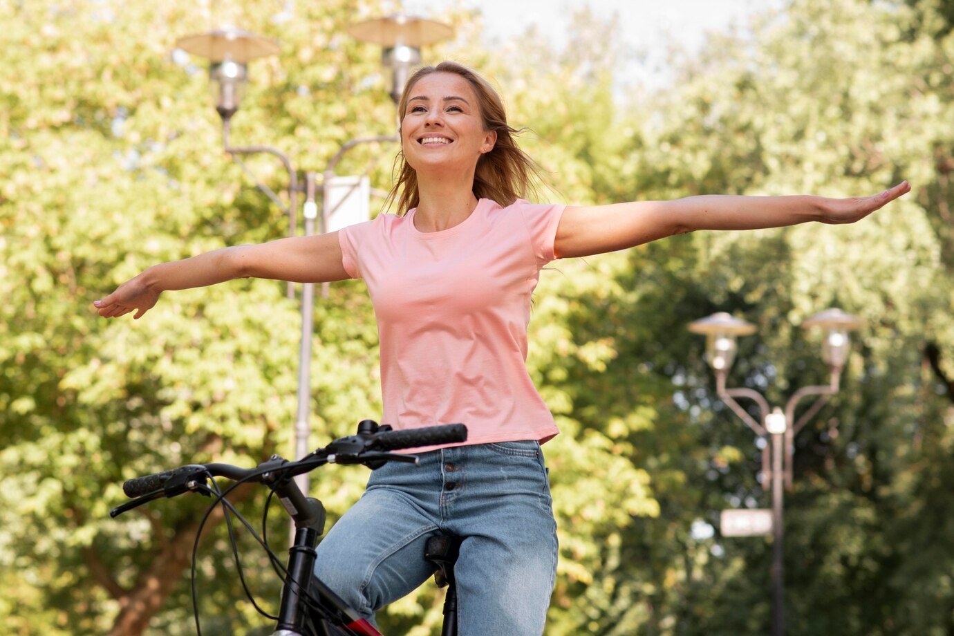 low-view-woman-riding-without-holding-bike-with-hands_23-2148684612