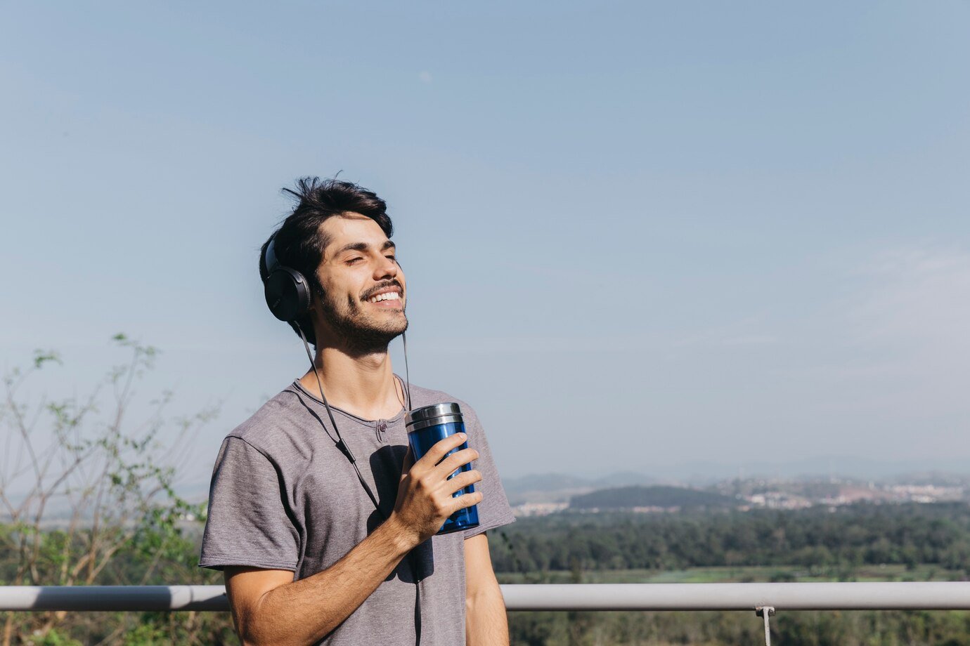 man-with-headphones-thermocup_23-2147747882