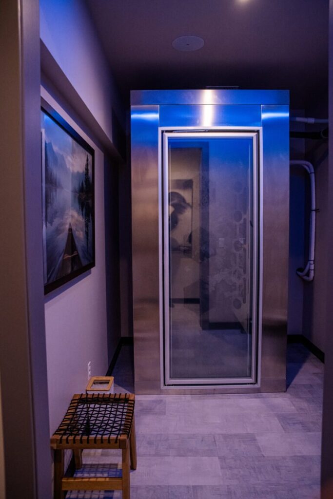 Client undergoing whole-body cryotherapy treatment at Elysian Institute in Montana