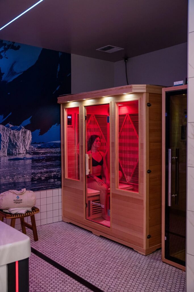 Person relaxing in infrared sauna therapy session at Elysian Institute in Montana