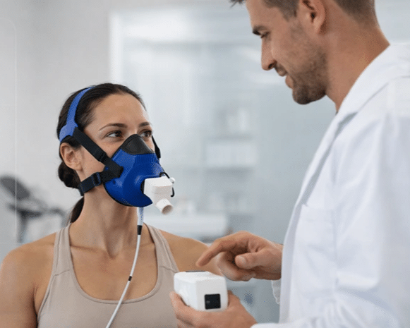 Clinician fitting a metabolic testing mask on a client during assessment