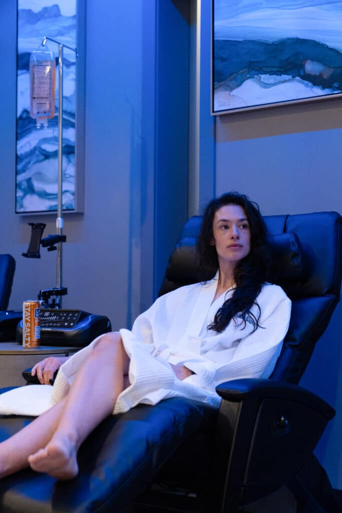 Woman relaxing in a recliner during a PEMF therapy session
