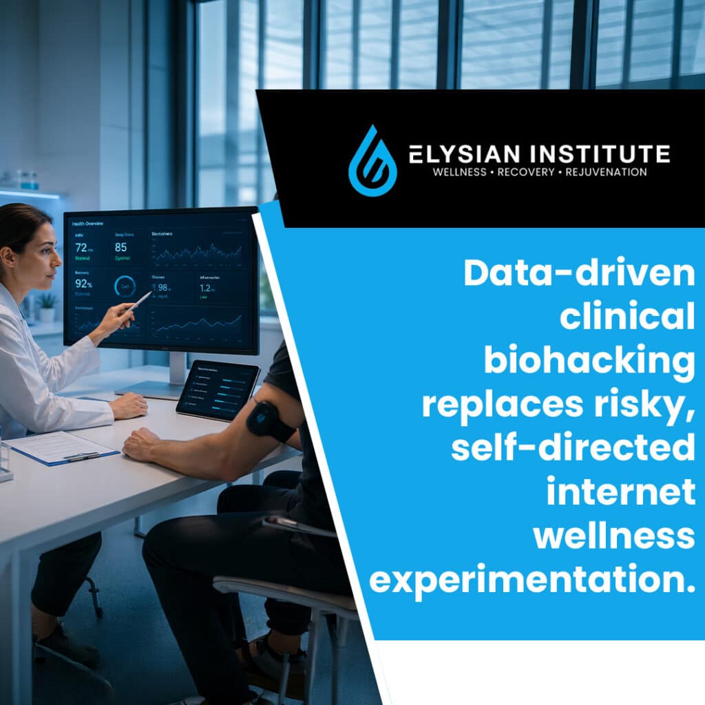 A clinician pointing to health metrics on a desktop monitor while reviewing health data with a patient wearing a wearable sensor.
