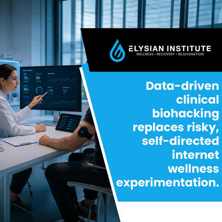 A clinician pointing to health metrics on a desktop monitor while reviewing health data with a patient wearing a wearable sensor.