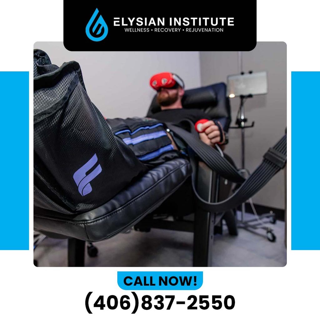 A man relaxing in a treatment chair wearing full-leg pneumatic compression boots and light therapy goggles for advanced athletic recovery.